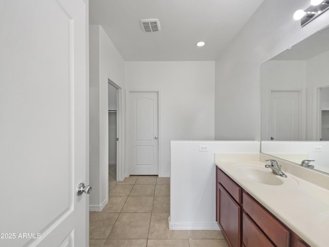 bathroom with tile patterned floors, visible vents, vanity, and baseboards