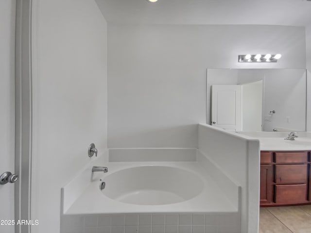 full bathroom with a garden tub, vanity, and tile patterned flooring