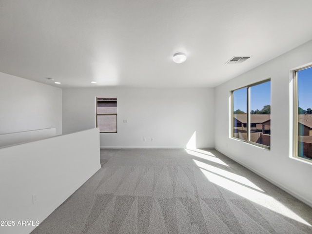 unfurnished room with recessed lighting, carpet flooring, baseboards, and visible vents