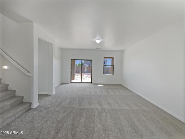 interior space with carpet flooring, stairs, and baseboards