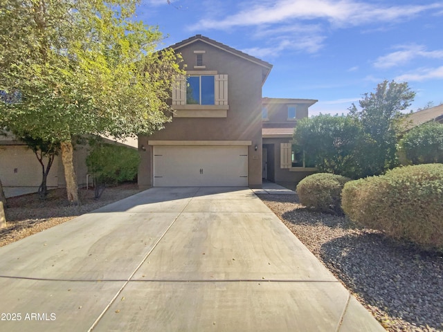 traditional-style house featuring stucco siding, concrete driveway, and an attached garage