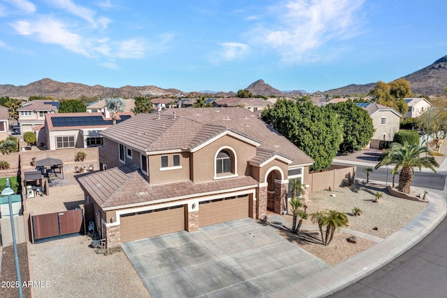 view of front facade featuring a garage and a mountain view