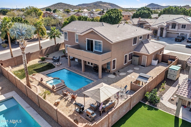 view of pool with a mountain view and a patio area