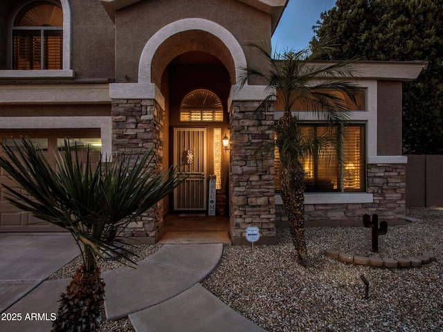 view of exterior entry with a garage