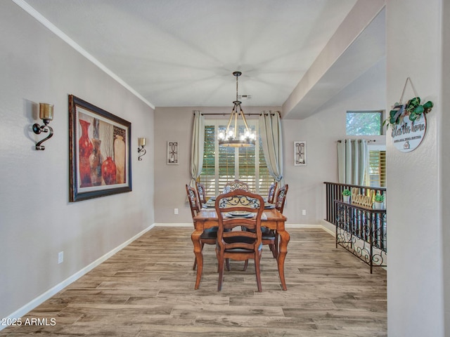 dining space with a chandelier and light hardwood / wood-style flooring