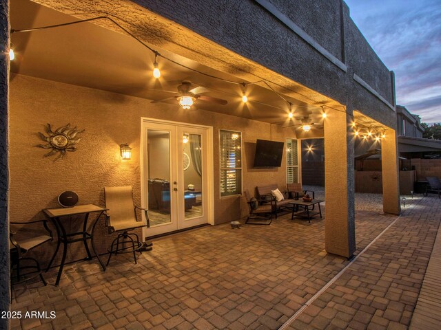 view of patio / terrace featuring french doors, ceiling fan, and an outdoor living space