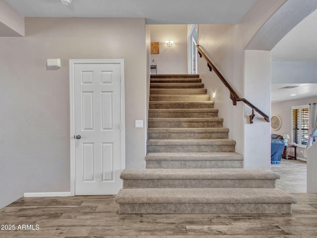 stairs featuring hardwood / wood-style flooring