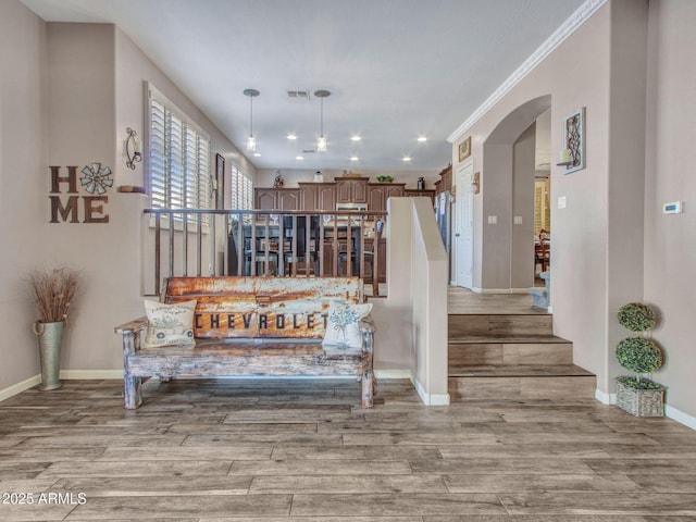 stairway featuring hardwood / wood-style flooring and crown molding