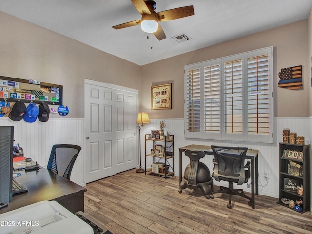 home office featuring hardwood / wood-style floors and ceiling fan