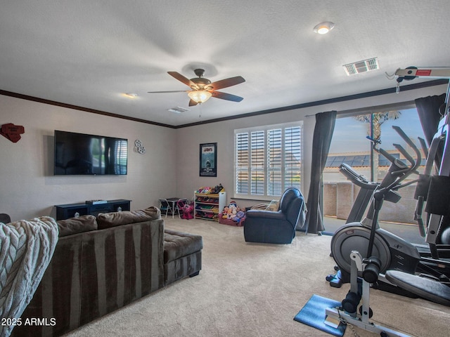 carpeted living room with ornamental molding, ceiling fan, and a textured ceiling