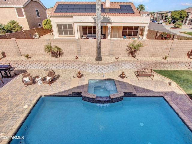 view of swimming pool featuring an in ground hot tub and a patio area