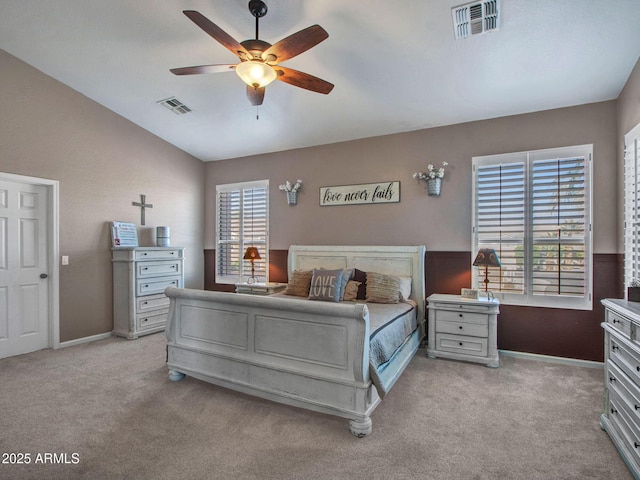 carpeted bedroom with vaulted ceiling and ceiling fan