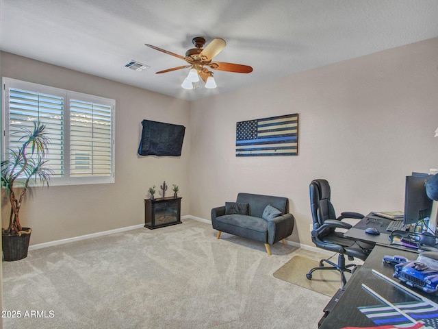 carpeted office with ceiling fan