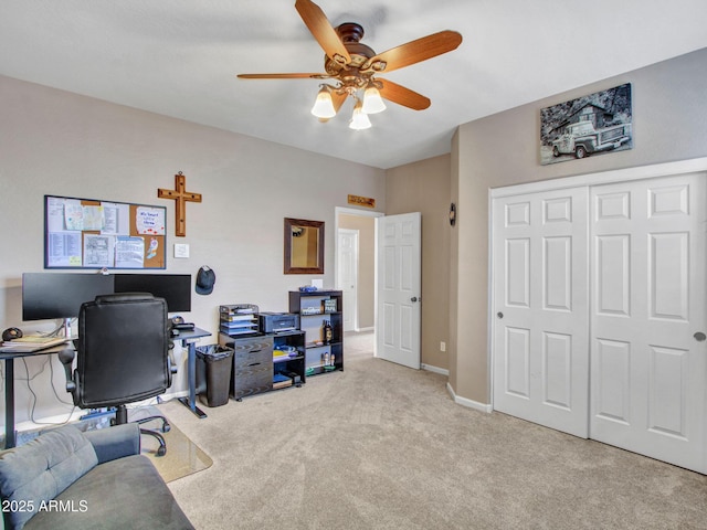 carpeted home office with ceiling fan