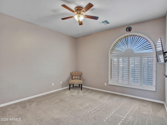 carpeted empty room featuring ceiling fan