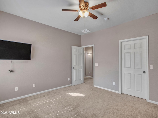 unfurnished bedroom with light colored carpet and ceiling fan