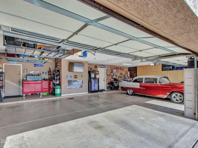 garage with a garage door opener and a workshop area