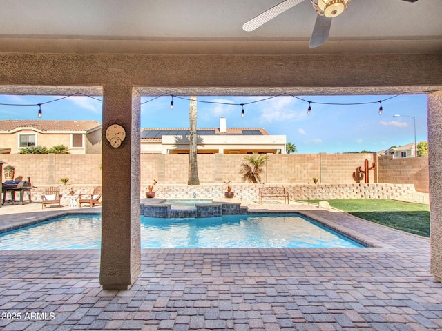 view of swimming pool featuring ceiling fan and an in ground hot tub