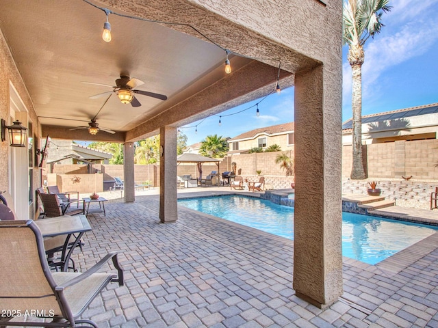 view of pool with a patio and ceiling fan