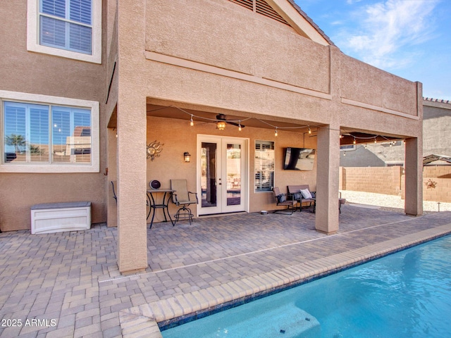 view of pool featuring a patio, french doors, and ceiling fan