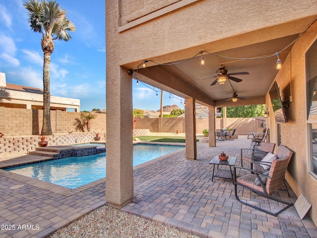 view of pool featuring a patio area, ceiling fan, and an in ground hot tub