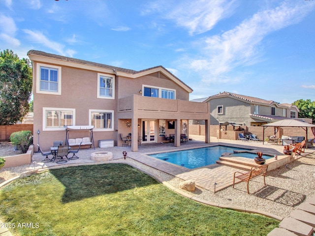 view of pool with a lawn, a gazebo, a patio, and a fire pit