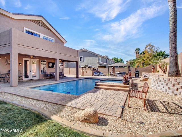 view of pool with ceiling fan, a gazebo, a patio area, french doors, and an in ground hot tub