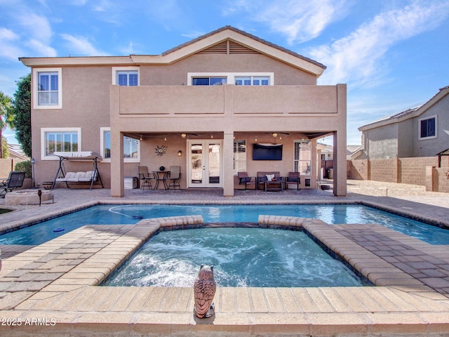 view of swimming pool with an in ground hot tub, ceiling fan, a patio area, and french doors