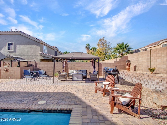 view of patio with a gazebo and an outdoor living space with a fire pit