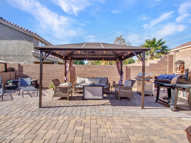 view of patio / terrace with a gazebo, area for grilling, and an outdoor living space with a fire pit