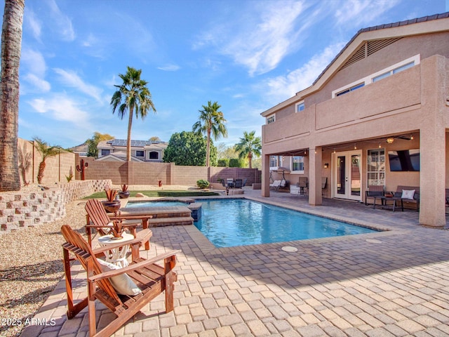 view of swimming pool featuring an in ground hot tub, a patio, and french doors