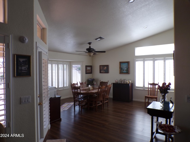 dining room featuring a textured ceiling, vaulted ceiling, ceiling fan, and dark wood-type flooring