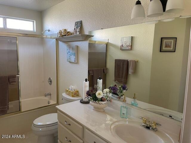 full bathroom with shower / bath combination with glass door, vanity, and toilet