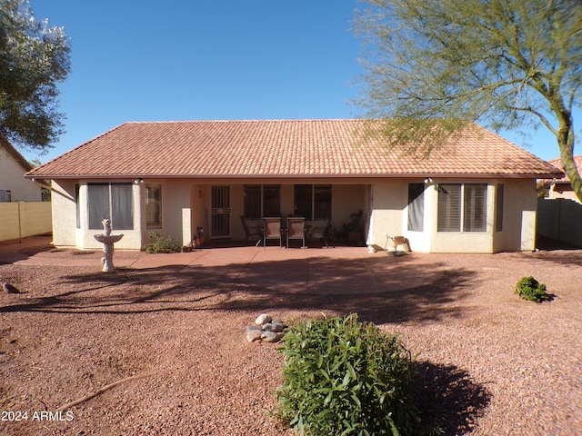 rear view of property featuring a patio area