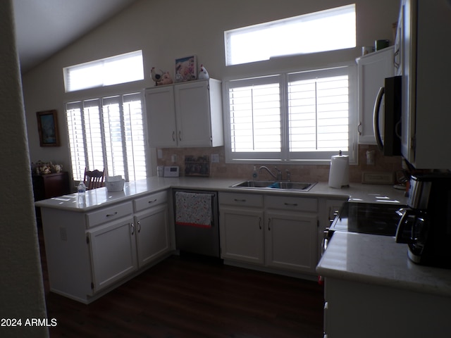 kitchen with sink, stainless steel appliances, dark hardwood / wood-style floors, kitchen peninsula, and white cabinets