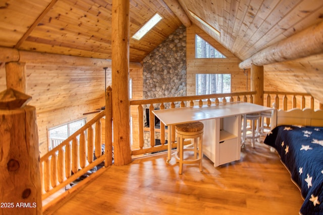 bedroom featuring beamed ceiling, a skylight, high vaulted ceiling, wooden ceiling, and hardwood / wood-style flooring