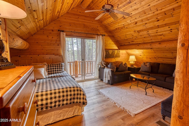 bedroom with access to exterior, wood ceiling, wooden walls, and light wood-type flooring