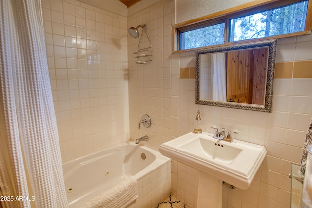 bathroom with tile walls and shower / tub combo with curtain