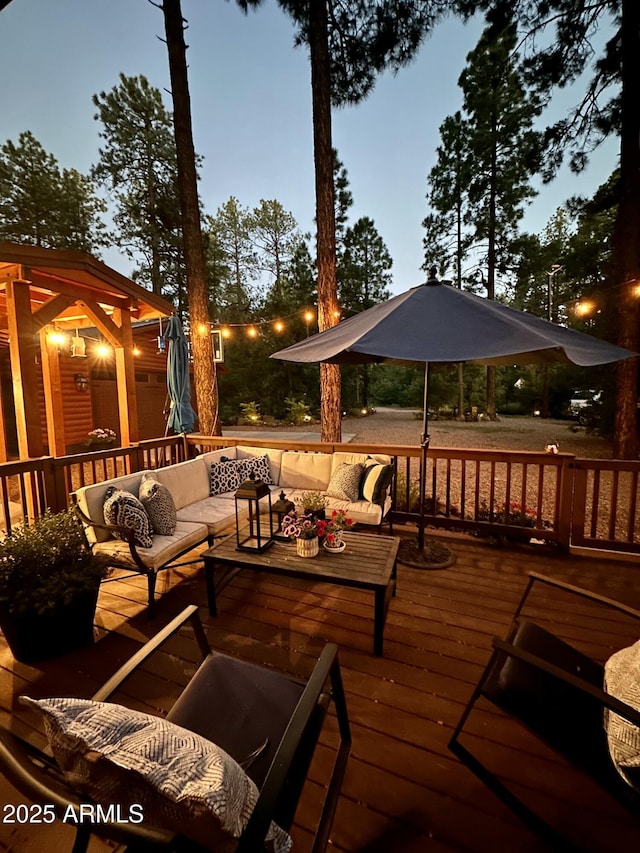 deck at dusk featuring an outdoor hangout area