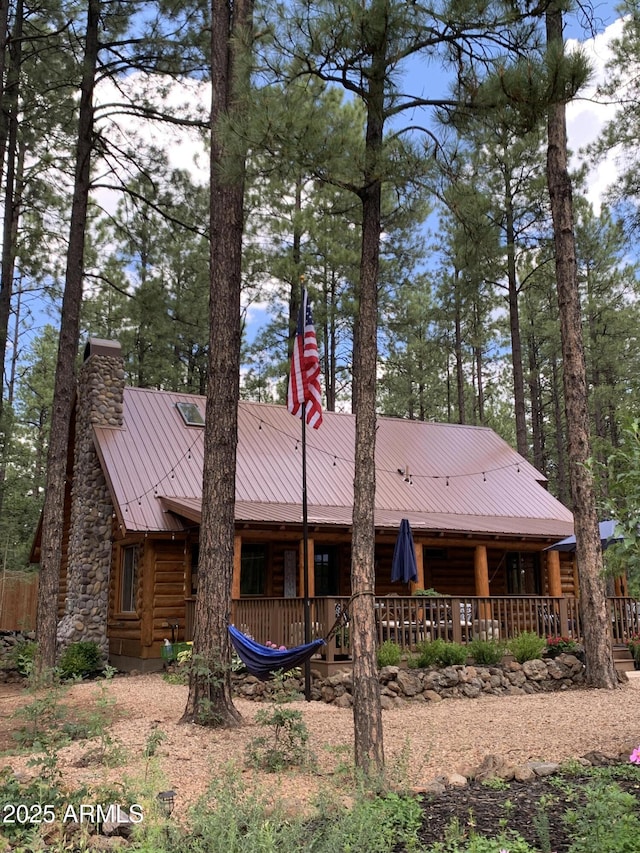 back of property with covered porch