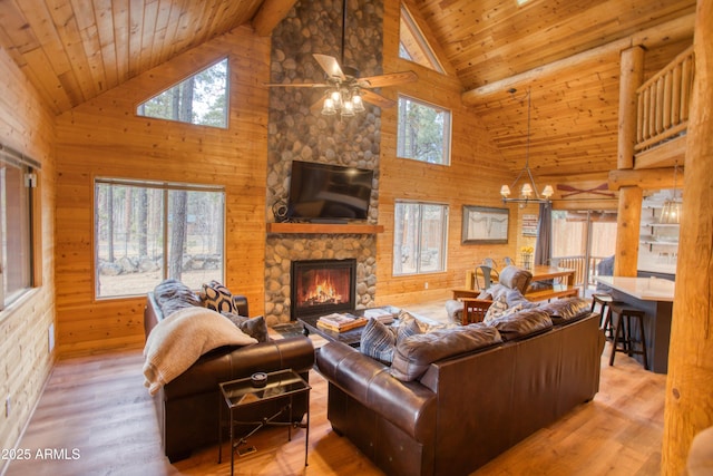 living room featuring a stone fireplace, wooden ceiling, and light wood-type flooring