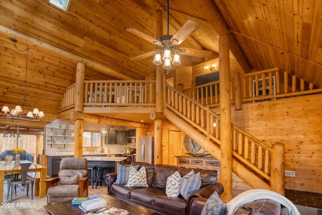 living room featuring lofted ceiling, ceiling fan with notable chandelier, and wooden ceiling