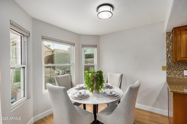 dining space featuring light hardwood / wood-style floors and a healthy amount of sunlight