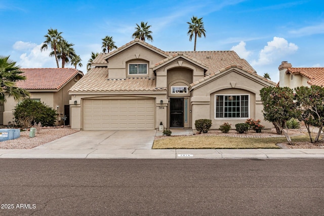 mediterranean / spanish-style home with a garage