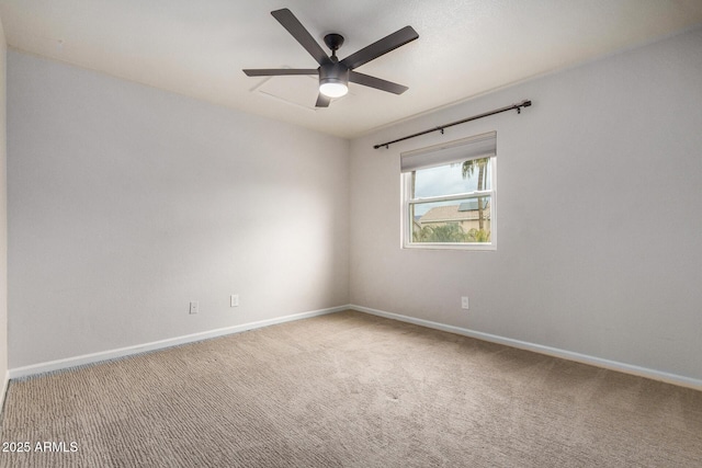 spare room featuring ceiling fan and carpet floors