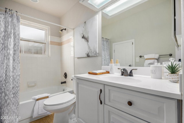 full bathroom featuring vanity, toilet, shower / bath combination with curtain, and a skylight