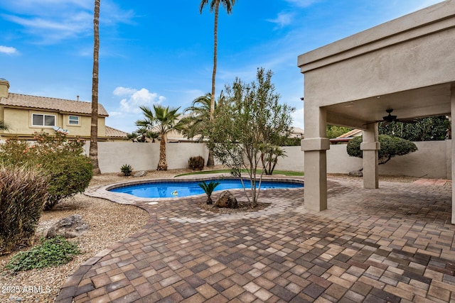 view of pool with ceiling fan and a patio area