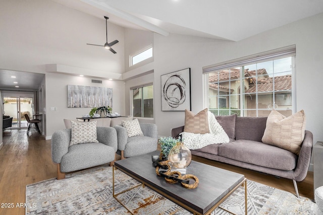 living room featuring hardwood / wood-style flooring, plenty of natural light, high vaulted ceiling, and ceiling fan