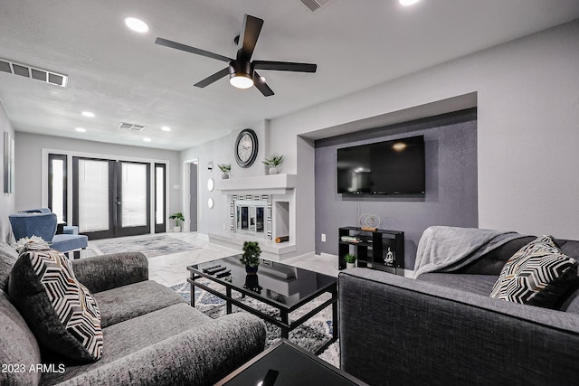 living room with a ceiling fan, visible vents, recessed lighting, and marble finish floor