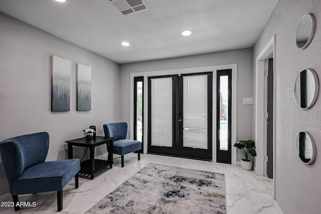 entryway with recessed lighting, visible vents, marble finish floor, and french doors